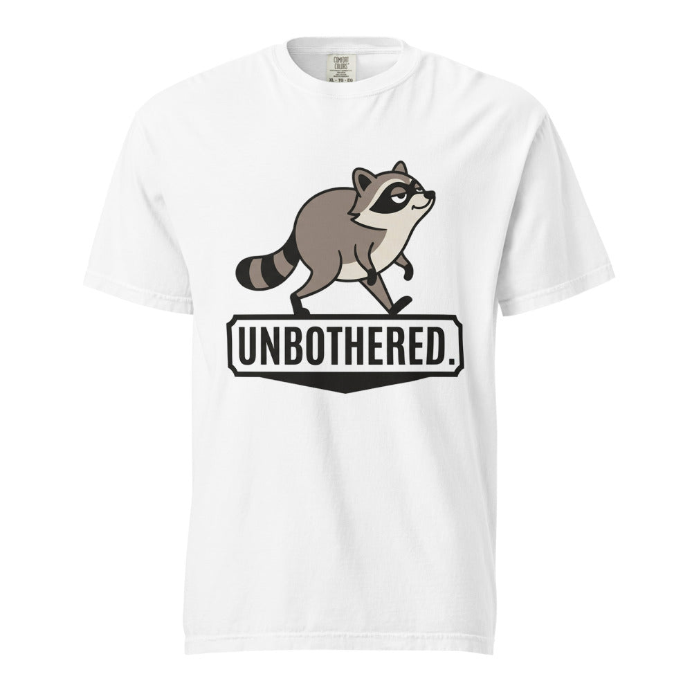 White heavyweight tee with a cartoon raccoon strutting above the word UNBOTHERED.