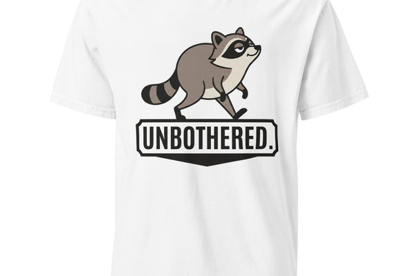 White heavyweight tee with a cartoon raccoon strutting above the word UNBOTHERED.